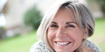 Senior woman enjoying the benefits of All-on-4 dental implants