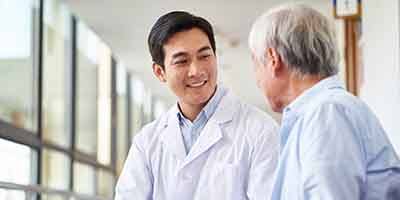 Older man speaking to oral facial surgeon