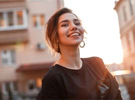 Woman with dental implants in Carmichael, CA walking outside