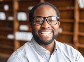 Man with glasses and dental implants in Carmichael, CA smiling