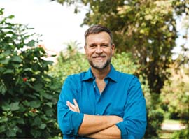 Older bearded man with dental implants in Carmichael, CA outside and smiling