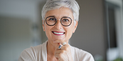 Smiling senior woman who cares well for her dental implants