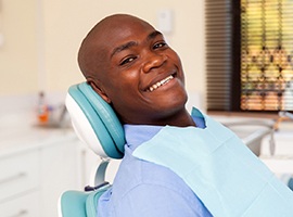 Man smiles after getting dental implants in Carmichael