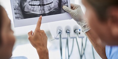 dentist and patient discussing advanced dental implant procedures in Carmichael