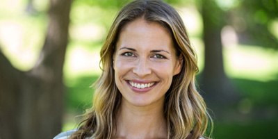 Woman in striped shirt outside and smiling