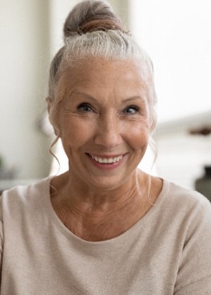 woman smiling and giving thumbs up