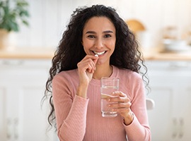 Smiling woman preparing to take sedative