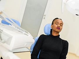 Patient with closed eyes, relaxing in treatment chair