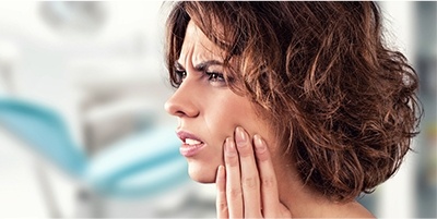 Woman in pain holding jaw