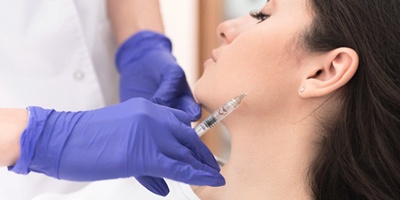 Woman undergoing BOTOX® injections as part of TMJ therapy