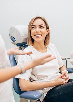 patient smiling while talking to dentist