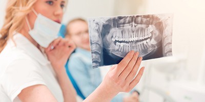 Lip & Tongue Tie Treatment patient looking at dental X-ray