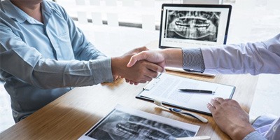 patient shaking hands with dentist