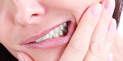 Closeup of patient holding jaw