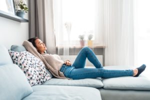 Woman resting at home after wisdom tooth removal