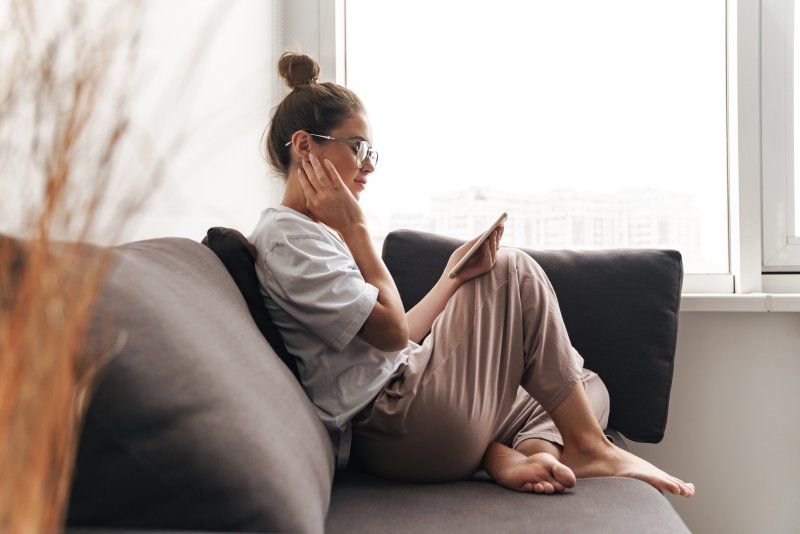 Woman with dental implants resting at home