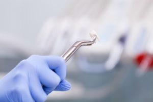 Tooth held in dental forceps following tooth extraction 