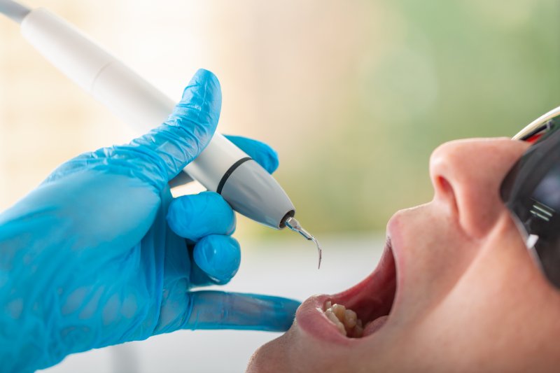 dentist examining patient’s mouth 
