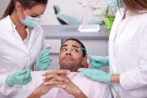 Dental patient with fearful expression on his face