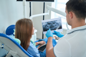 a dentist and patient viewing an X-ray