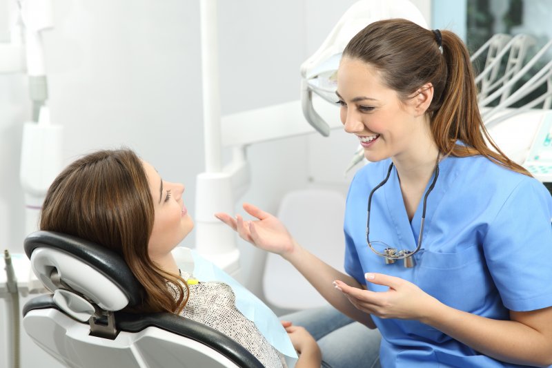  dentist explaining dental implant surgery to patient