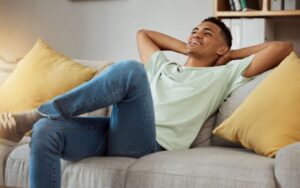 Young man relaxing on sofa at home