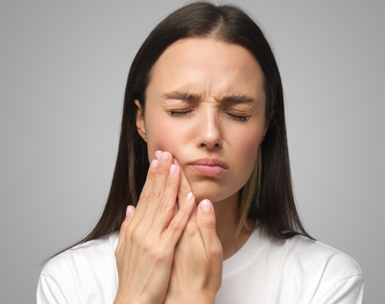 Woman holding side of jaw